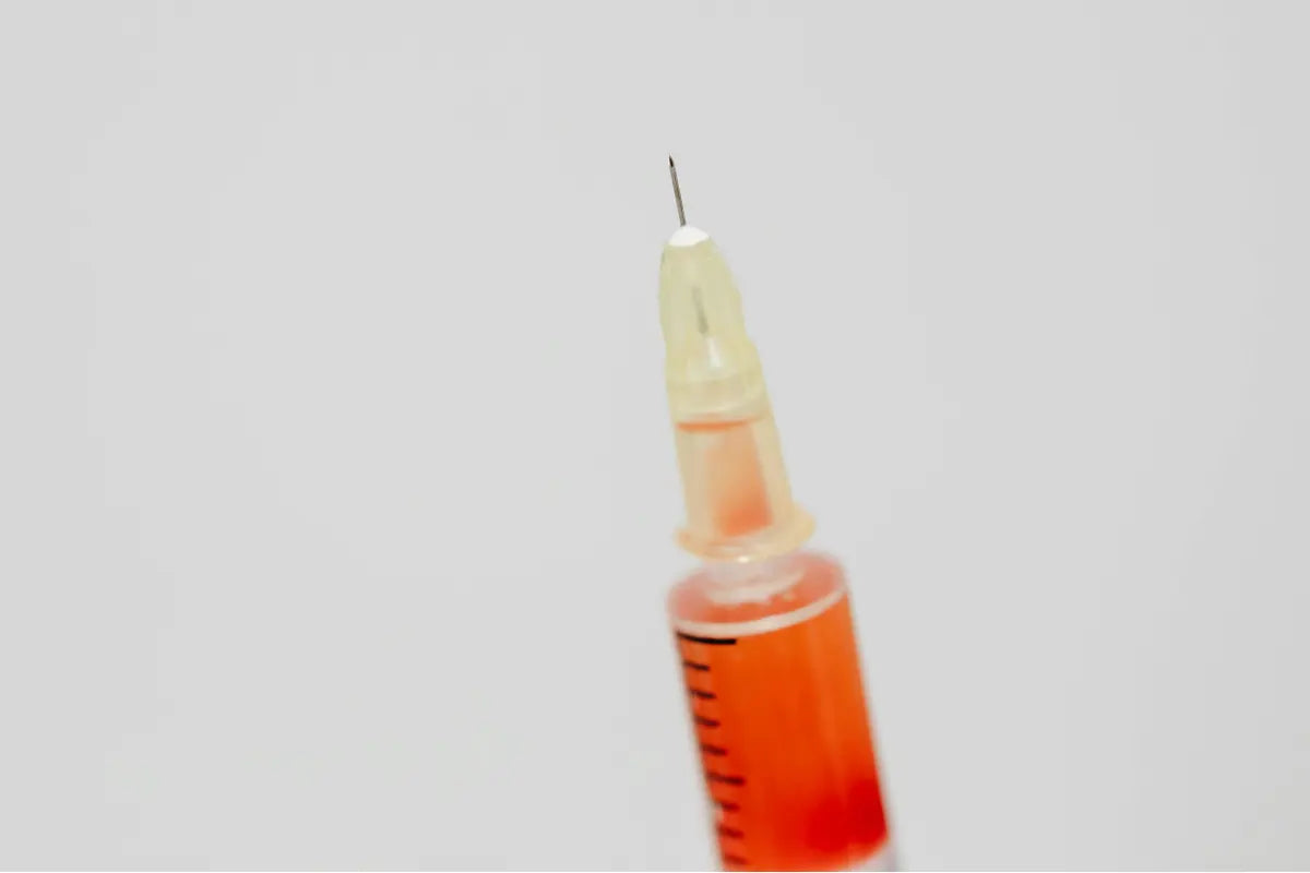 Close-up on the tip of a syringe commonly used for microneedling or injection procedures.