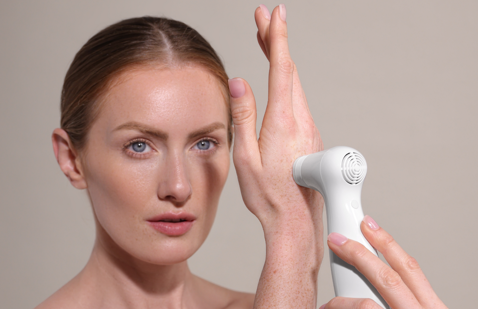 Woman using an anti-aging laser to get rid of hand wrinkles