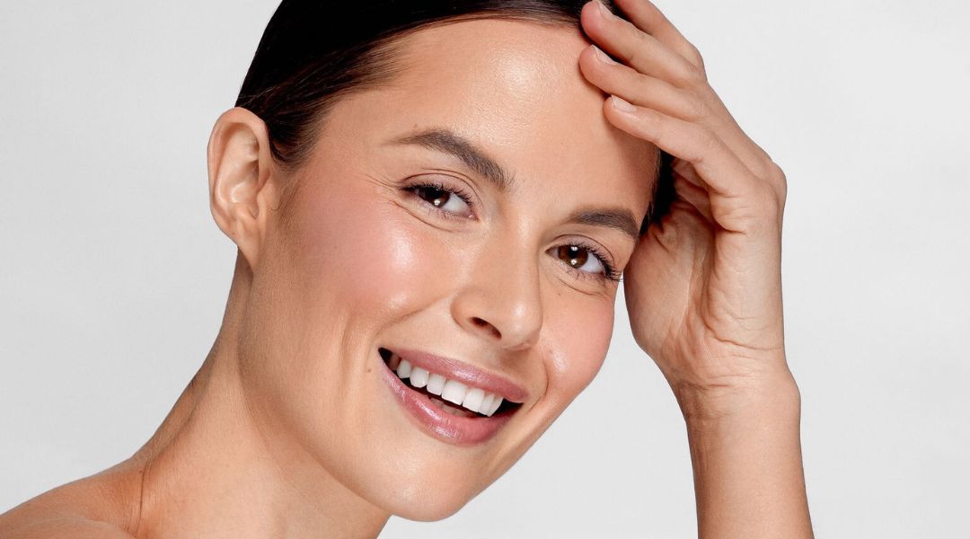 Smiling woman with good skin texture after using the NIRA laser