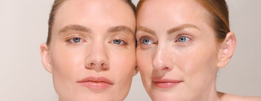 Close up of two women with radiant skin after using NIRA’s anti-aging skincare system