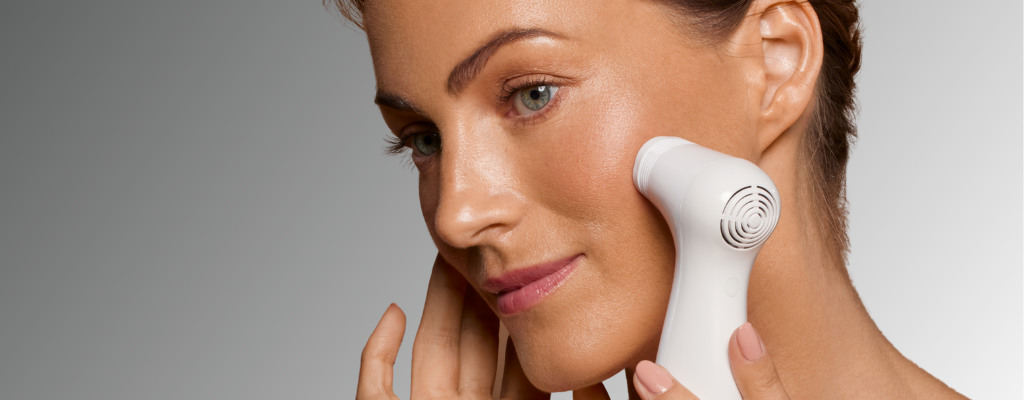 Woman using an at-home non-fractional laser to renew skin and reduce fine lines and wrinkles