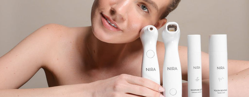 Woman with glowing skin using NIRA’s anti-aging skincare system