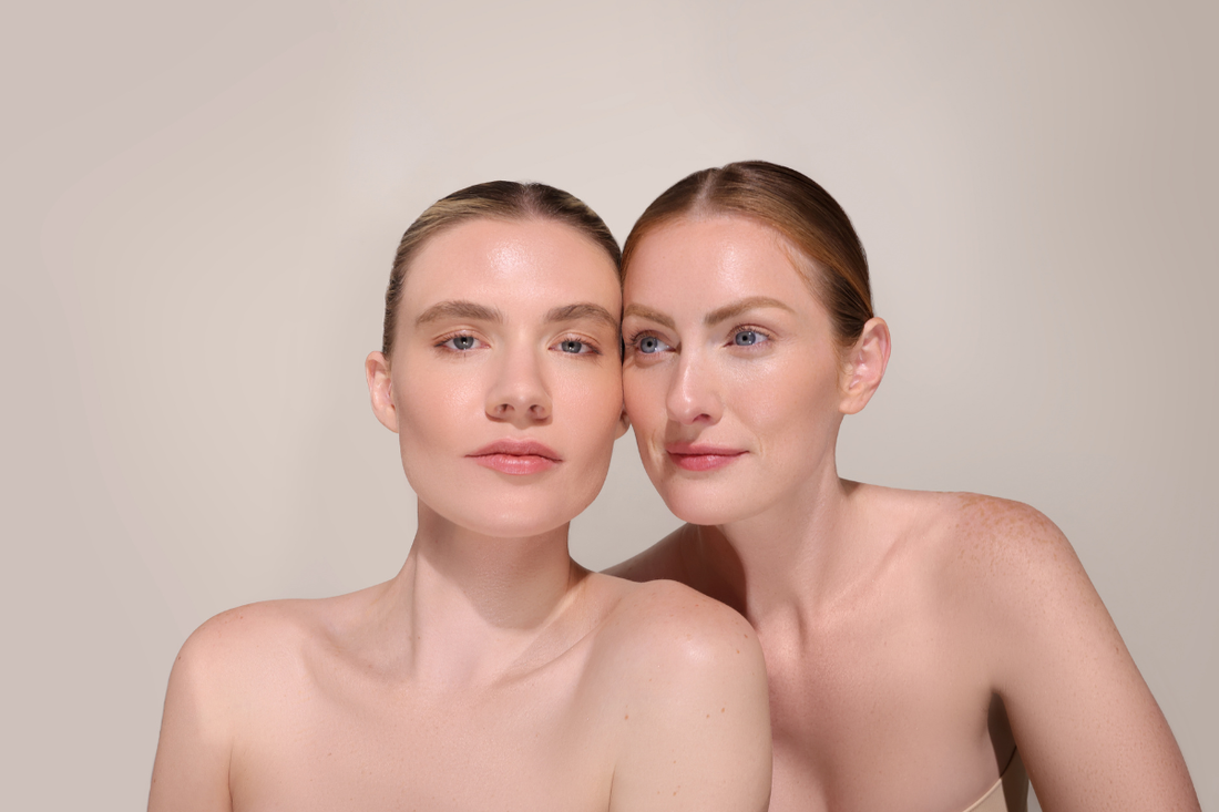 Two models with glowing, radiant skin standing next to each other showcasing healthy, youthful complexions