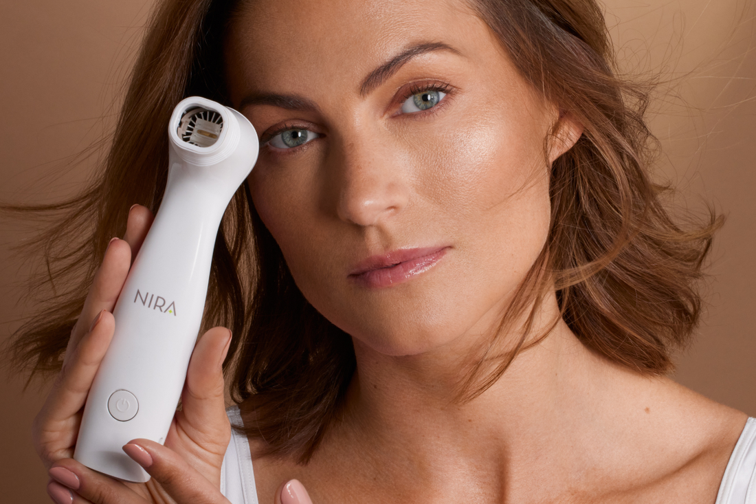Confident woman holding the NIRA Pro laser, a dermatologist-trusted device for collagen renewal.