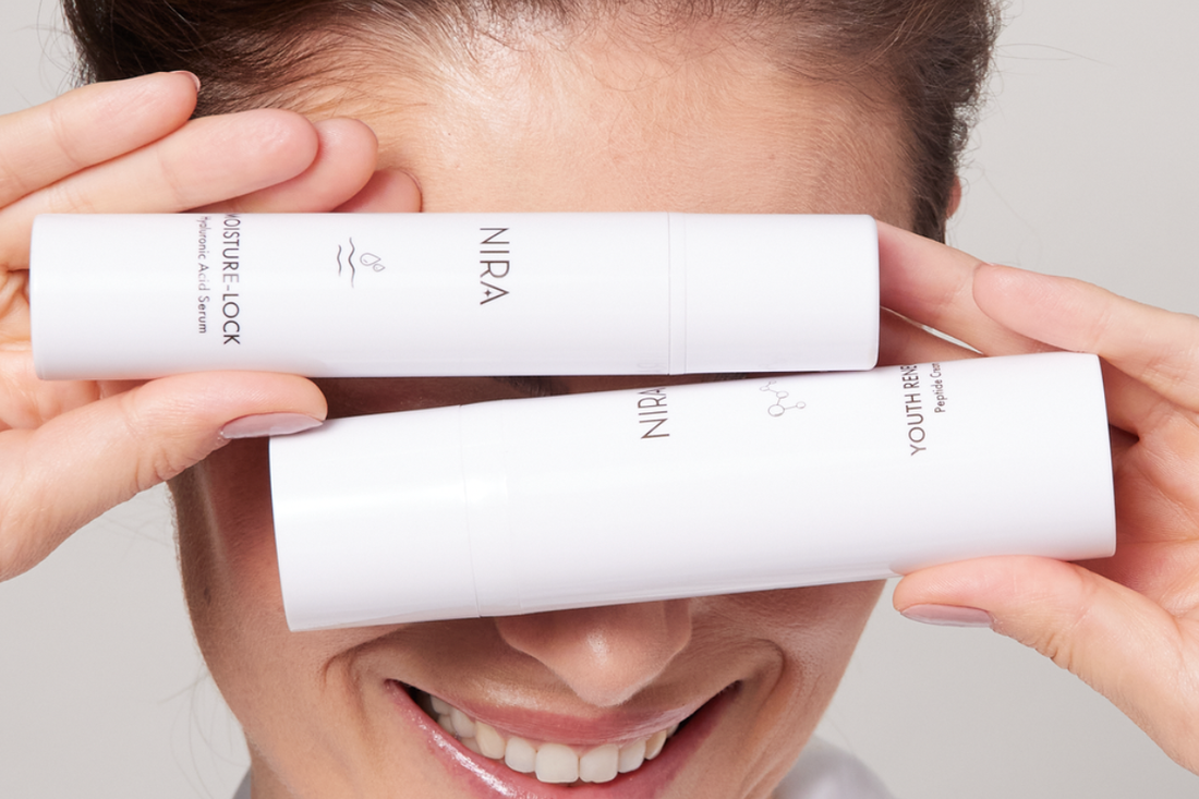 Smiling model holding NIRA Skin at-home laser in front of her face, showcasing radiant, youthful skin.