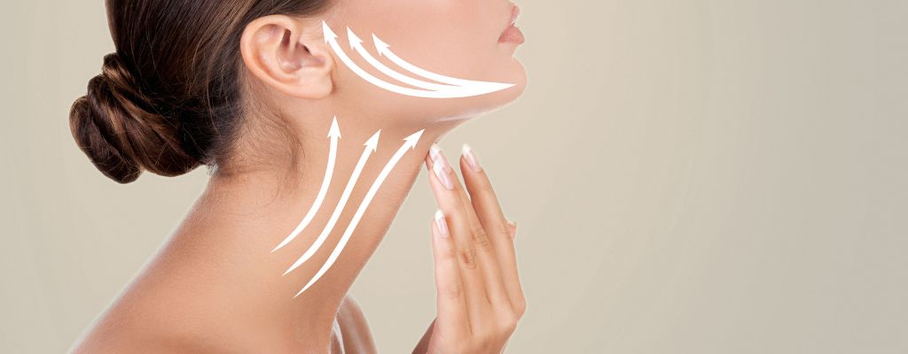 Woman showcasing her jawline and neck with white arrows that indicate skin tightening techniques for the chin