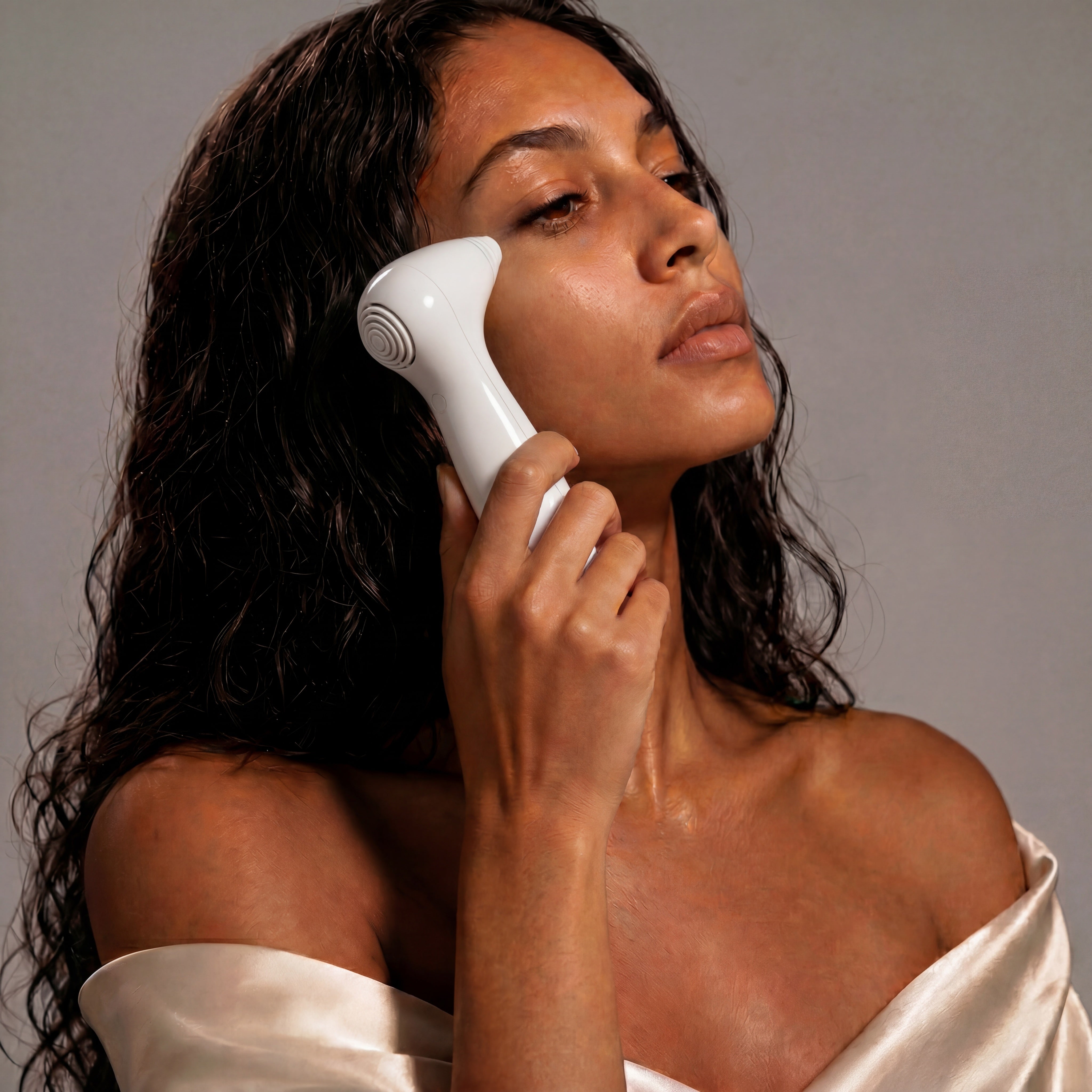 White handheld facial device nira precision laser with smooth curved design and circular textured head for skincare use