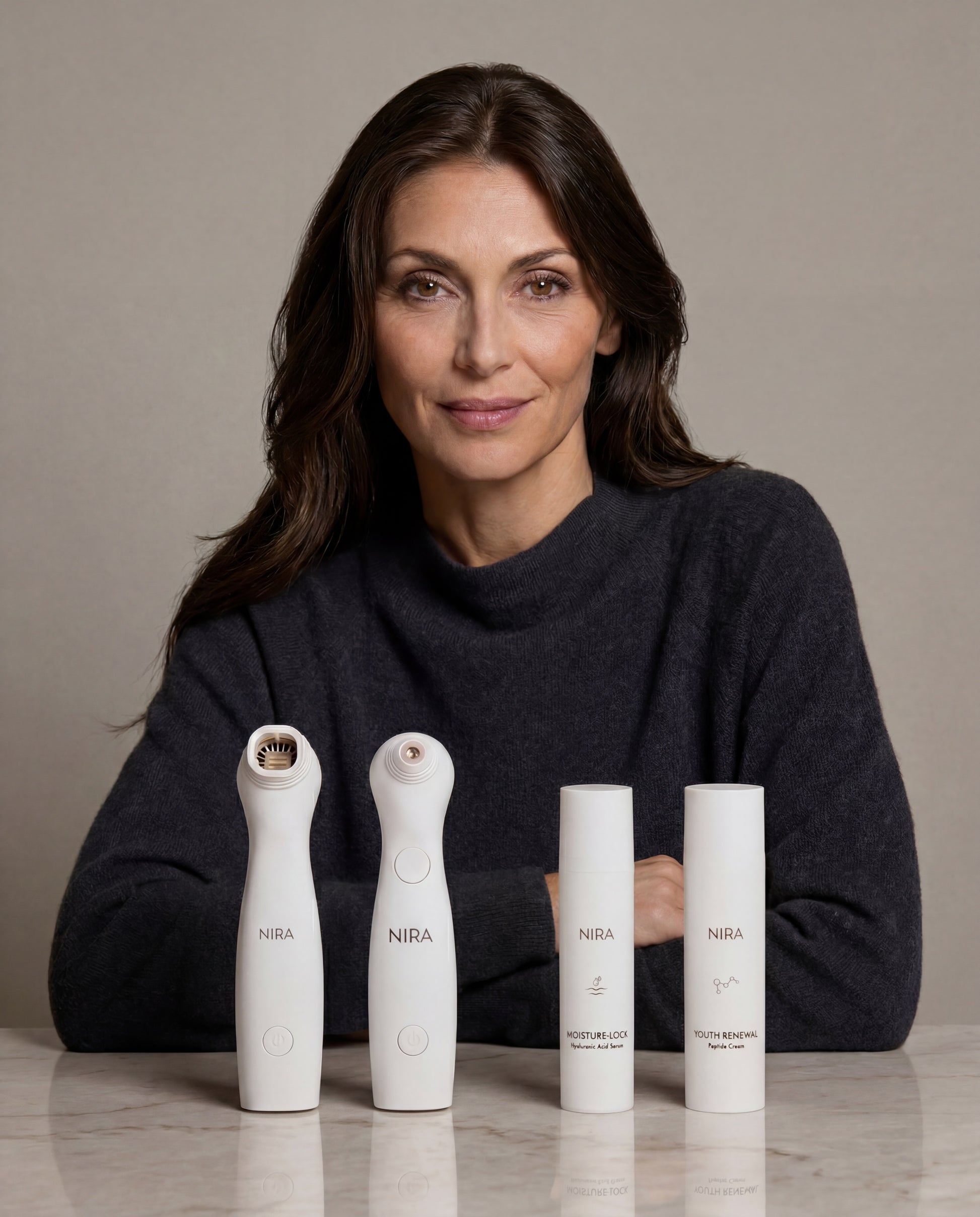Two sleek white nira skincare devices and matching moisture-lock and youth renewal bottles in nira pro 3 ultimate bundle