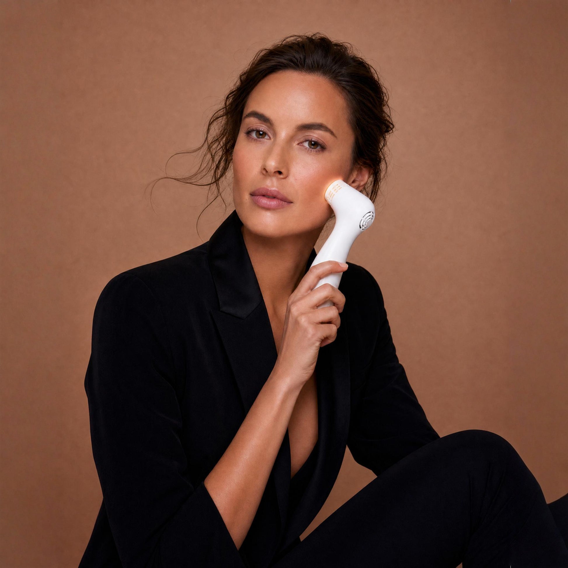 White handheld nira pro 3 laser facial device with sleek curved design for skin treatment and rejuvenation