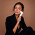 White handheld nira pro 3 laser facial device with sleek curved design for skin treatment and rejuvenation