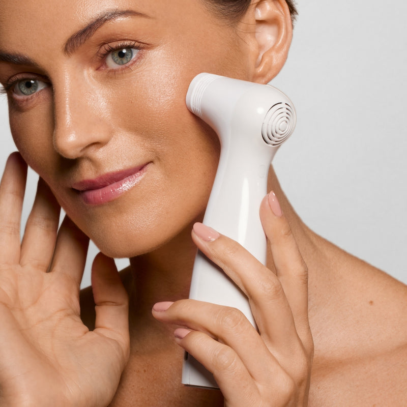 Woman with youthful skin using the NIRA Pro at-home Laser