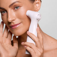 Woman with radiant skin using the NIRA Pro anti-aging laser from the NIRA Ultimate Laser Bundle