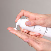 Person using Youth Renewal Peptide Cream to improve skin tone and texture