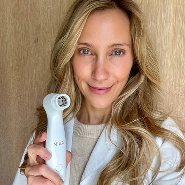 Dermatologist holding the NIRA Pro wrinkle reduction laser.
