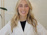 Dermatologist smiling with white lab coat