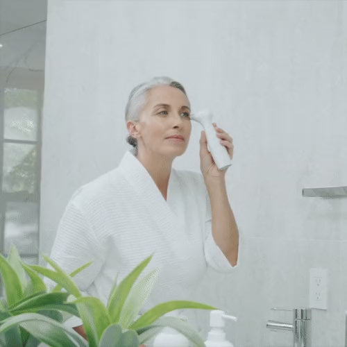 Cargar vídeo: Woman holding the NIRA Precision laser to the skin around her eye while listening for the reject tone