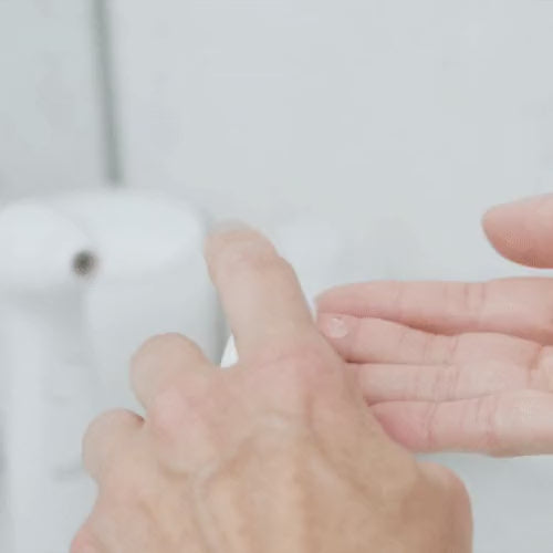 Reaching for NIRA serum on the bathroom counter to replenish the skin after a Precision treatment